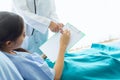 The patient, an Asian woman, is testing the writing of letters. With the right hand On white paper To test the hand senses As