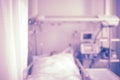 Patient bed in intensive care unit, unfocused background