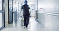 Patient, bed and nurse walking in hospital, hallway or corridor to surgery, operation room or ER healthcare service Royalty Free Stock Photo