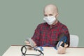 Patient breast cancer bald woman controls your blood pressure in a sterile mask