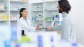 Patient buying medicine from pharmacist at the pharmacy store. Customer receives prescription medication at the chemist