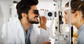 Patient or customer at slit lamp at optometrist or optician