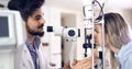 Patient or customer at slit lamp at optometrist or optician