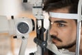 Patient or customer at slit lamp at optometrist or optician Royalty Free Stock Photo