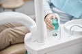 Patient of a dental clinic getting some water to rinse his mouth Royalty Free Stock Photo