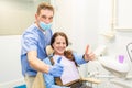 Patient and dentis showing thumbs up together Royalty Free Stock Photo