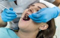 Patient in dentistry with stomatological tools, closeup