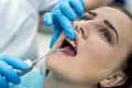 Patient in dentistry with stomatological tools, closeup