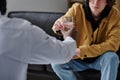 Patient drinking water at psychologist office Royalty Free Stock Photo