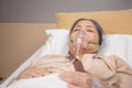 Patient elderly asleep with disease or unconscious in oxygen mask on bed at hospital ward, senior sick urgency.