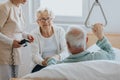 Patient gets up from the hospital bed by helping himself with a special handle