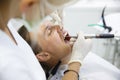 Patient getting her gum pocket depth measured