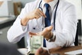 Patient giving money to medical doctor in hospital setting. Doctor gladly accepts a bribe from the patient actively Royalty Free Stock Photo