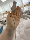 Patient hand with pulse oximetry probe in hospital intensive care unit Royalty Free Stock Photo