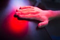 Patient hand in red physiotherapy heat treatment Royalty Free Stock Photo