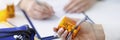 Patient holding jar of medicines in his hands against background of doctor closeup