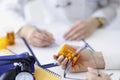 Patient holding jar of medicines in his hands against background of doctor closeup