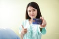 The patient holds a credit card to treat the disease. Get health benefits and more.