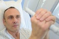Patient in hospital bed gripping hoist Royalty Free Stock Photo