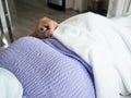 Patient laying on the bed in hospital holding medical switch in hand