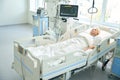 Patient lies on special bed in ward with modern equipment Royalty Free Stock Photo