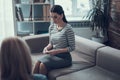 Woman listening to her psychologist and sitting on the couch indoors Royalty Free Stock Photo
