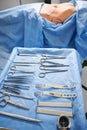 Patient lying near medical instruments in operating room. Royalty Free Stock Photo