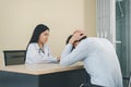 Patient man sad and talking with professional psychologist,Therapist conducting a consultation and counseling at hospital Royalty Free Stock Photo