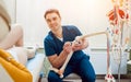 Patient with orthopedist doctor in his office.