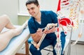 Patient with orthopedist doctor in his office.