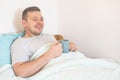 Patient person sleep on patient bed in hospital room. Sick man get happy, smile face. He recuperate for while. Patient male Royalty Free Stock Photo