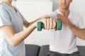 Patient at the physiotherapy doing physical exercises with his therapist