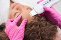 Patient on the procedure of hardware facial skin rejuvenation in clinic