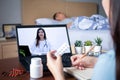 Patient`s relatives use video conference, make online consultation with doctor on notebook computer, ask doctor about illness