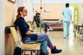 Patient sitting in hospital ward hallway waiting room with iv Royalty Free Stock Photo