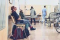 Patient sitting in hospital ward hallway waiting room with iv Royalty Free Stock Photo