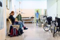 Patient sitting in hospital ward hallway waiting room with iv Royalty Free Stock Photo