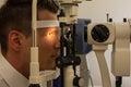 Patient at slit lamp of optician or optometrist