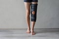 Patient standing with knee brace support after do posterior cruciate ligament surgery. Healthcare and medical concept Royalty Free Stock Photo