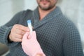 Patient takes a container with blood plasma from health worker