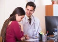 Patient and therapeutist at desk in clinic Royalty Free Stock Photo