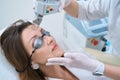 Patient undergoes a procedure for laser removal of neoplasms in the forehead Royalty Free Stock Photo