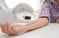 Patient undergoing skin allergy test at light table, Royalty Free Stock Photo