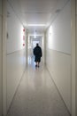 Patient walking alone in a hospital hallway