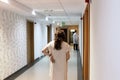 Patient walking in hospital hallway Royalty Free Stock Photo