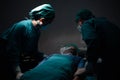 Patient wear a medical ventilator lying on the surgical bed in the operating room with surgeon stand by his side to keep an eye on Royalty Free Stock Photo