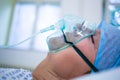 Patient wearing oxygen mask lying on hospital bed Royalty Free Stock Photo