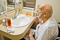 Patient in Wheelchair Shaving Royalty Free Stock Photo