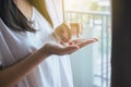 Patient woman with pills or capsules on hand and a glass of water Royalty Free Stock Photo