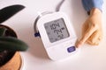 Patient woman using blood pressure and heart rate monitor for yourself at home Royalty Free Stock Photo